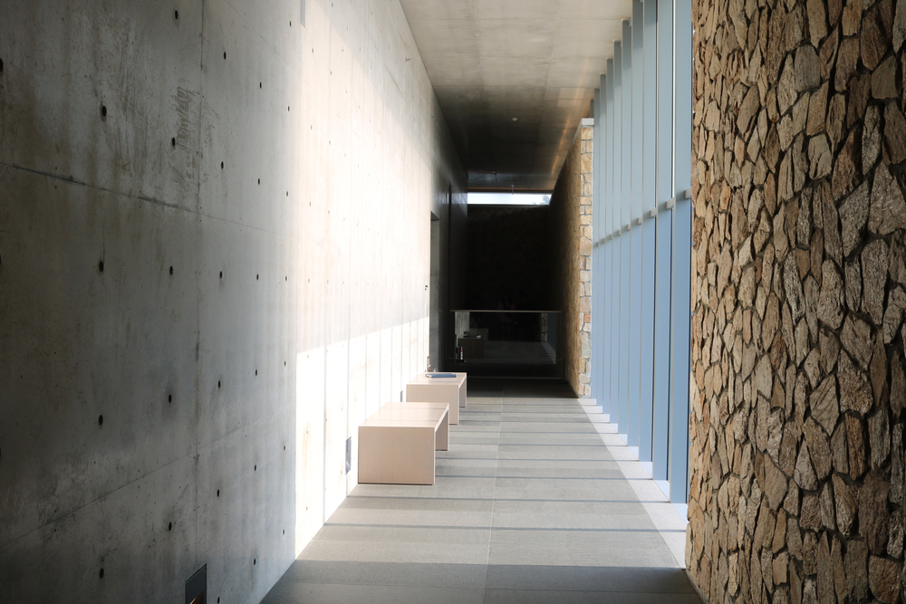A hallway made from exposed concrete of the modern art museum where the sun shines.