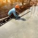 man hand spreading concrete mix with trowel in foundation. A construction worker is pouring cement and concrete,
